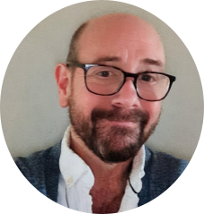 A person wearing glasses and a blue sweater
AI-generated content may be incorrect.